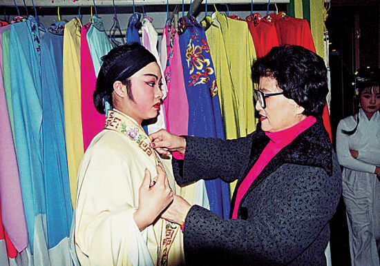 越剧表演艺术家王文娟为小演员穿演出服装